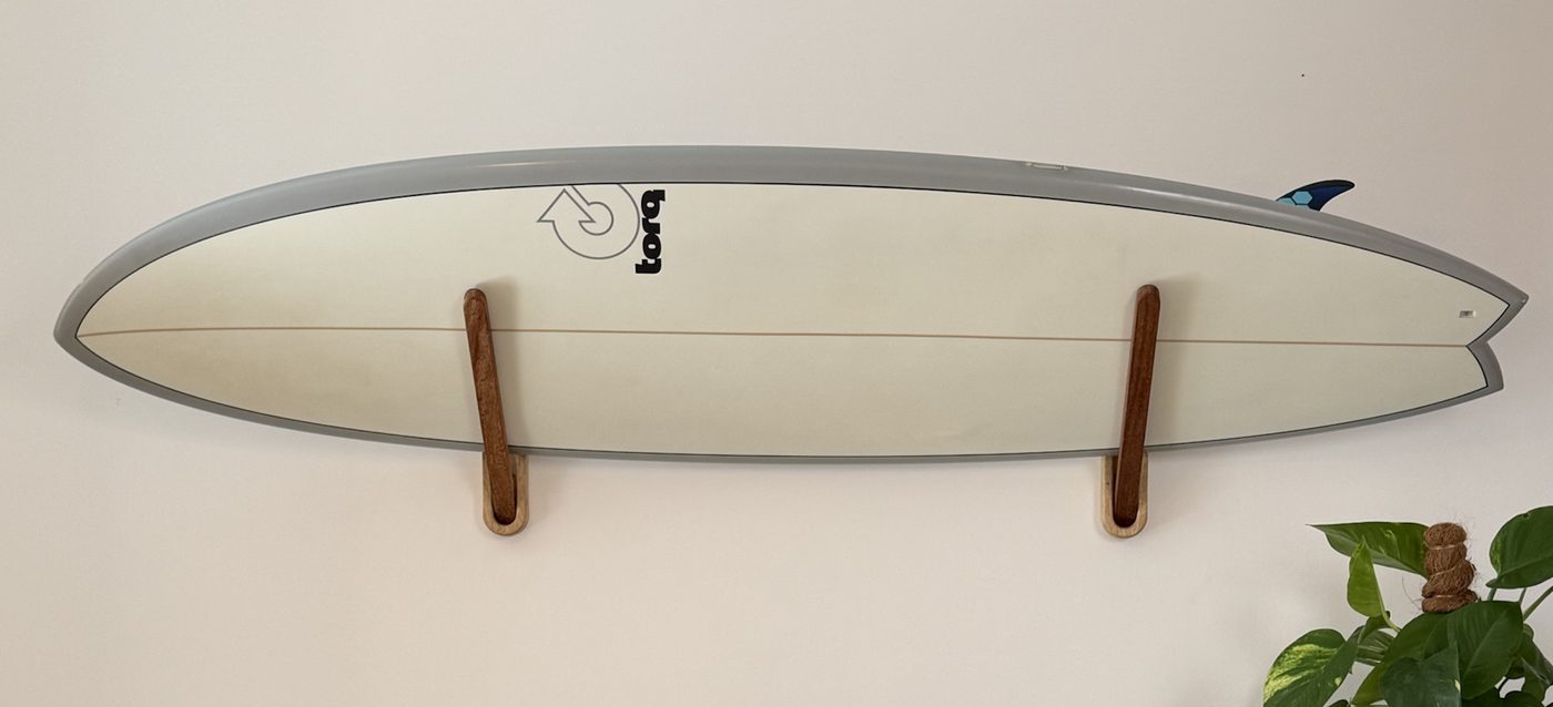 Surfboard resting on SOWOOD hardwood wall mounts